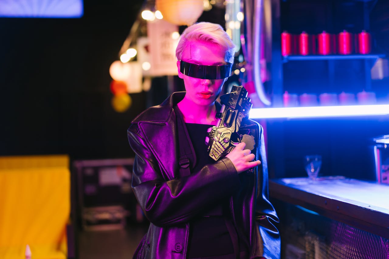 Stylish cyberpunk woman in dark room with futuristic eyewear and tech weapon.
