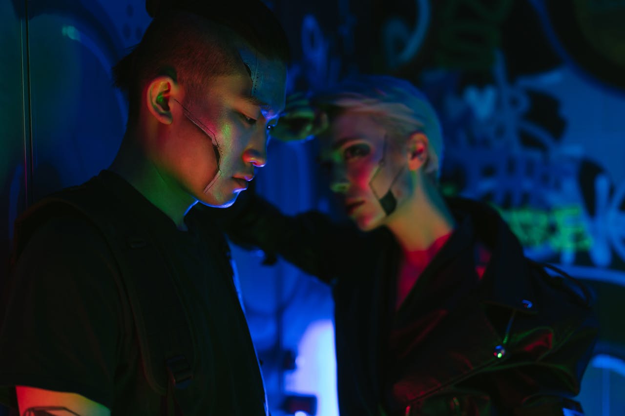 Cyberpunk style portrait of a man and woman in neon lighting, highlighting futuristic fashion aesthetics.